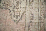 Oushak rug detail: dusty rose field, sandalwood tones, and geometric trellis motifs.