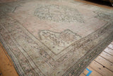 Corner of vintage Oushak carpet, detailed borders with trellis blossoms and scrolled tendril motifs.