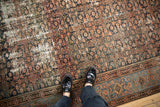 Worn field of the antique Hamadan carpet with visible Herati design and exposed knot heads.