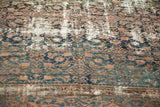 Antique Hamadan rug's low pile detail, revealing muted Herati pattern and visible knot heads.