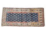 Antique Kurd runner featuring cobalt blue field with repeating plants, ivory serpent-pomegranate border.