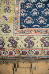 Terracotta and cobalt blue patterned border and secure fringed edge of an antique Kurd rug.