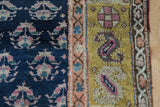 Antique Kurd runner's cobalt blue germinating plant field adjoining saffron yellow pomegranate border.