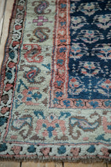 Textural depth and color abrashes in the antique Kurd rug's border and field.