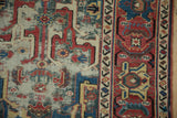 Antique Caucasian runner's Herati border, geometric arabesques, raspberry red, sapphire blue, visible pile wear.