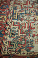 Geometric arabesques and significant wear with foundation showing through on an antique Caucasian runner.