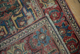 Storied wear on antique Caucasian runner's geometric arabesque field and Herati border.