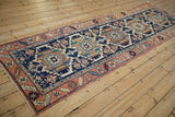 Vintage Karaja runner with geometric navy blue medallions and serrated leaves, rust border.