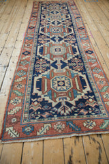 Hand-knotted end of a vintage Karaja runner with terracotta border and floral pattern.