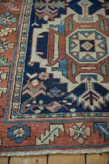 Karaja runner geometric border in navy, rust, and sky blue with light fringe.