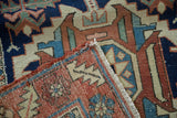 Vintage Karaja runner corner detail: hand-knotted geometric pattern in navy, rust, sky blue, with fringe.