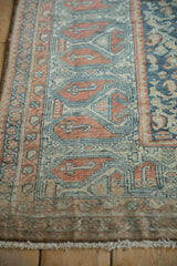 Textured Malayer rug pile with distressed geometric boteh motifs in dusty teal and terracotta.