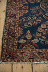 Antique Mohajeran Sarouk runner border: cherry red, dusty gold, bell flowers, serrated leaves, tattered edge.