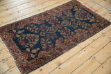 Aged corner of antique Mohajeran Sarouk, featuring cobalt blue field, raspberry florals, and minor edge roll.