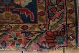 Antique Mohajeran Sarouk rug: tattered edge with worn floral motifs in blues and reds.