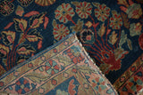 Antique Mohajeran Sarouk rug with hand-knotted back, woven border, and cobalt blue floral field.