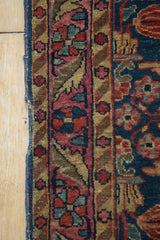 Storied edge of an antique Mohajeran Sarouk rug, featuring a period-correct painted red border.
