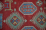 Stylized crab and ram's horn minor medallions on a late 19th-century Fachralo Kazak collector rug.