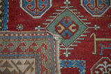 Detailed view of an antique Kazak rug's hand-knotted construction and woven foundation.