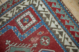 Corner of an antique Fachralo Kazak rug with geometric and wave-motif borders.