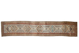 Vintage distressed Malayer runner, repeating geometric and floral medallions, ivory, rust, sky blue.