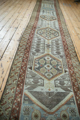 Distressed Persian Malayer runner border detail: faded geometric patterns in rust, beige, and brown tones.