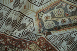 Distressed Malayer rug detail, featuring geometric motifs and worn pile in brown, beige, and rust.