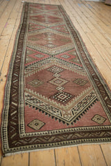 Vintage Caucasian runner with serrated medallions and pawn border in aubergine, brown, ivory.