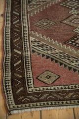 Caucasian rug border with reciprocating pawn motif, dusty aubergine field, and even wear.