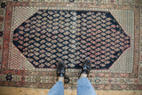 Antique Persian Malayer rug with a dark navy field, allover ivory and fuchsia boteh pattern.