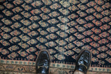 Antique Malayer rug's field with navy, ivory, fuchsia stylized boteh motifs, showing foundation wear.