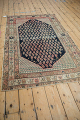 Antique Persian Malayer rug's dark navy field, fuchsia boteh patterns with birds and animal motifs.