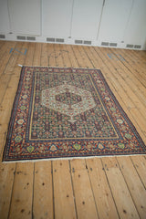 Vintage Senneh rug with a hexagonal medallion and Herati field, viewed from a high angle.