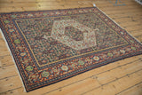 Angled view of a vintage Senneh rug, showing its hexagonal medallion and complex Samovar Turtle border.