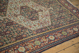 Angled detail of a vintage Senneh rug showing the Samovar Turtle border and intricate Herati field.