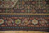 A close view of the vintage Senneh's main Samovar Turtle border and the dark navy blue Herati field.