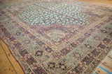 Intricate multi-tiered borders with scrolling Islimi and blossoms on antique Kermanshah carpet.