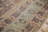 Antique Kermanshah carpet's multi-tiered borders showing scrolling Islimi, millefleur, and blossoms.