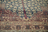 Antique Kermanshah carpet: tree of life motif, millefleur blossoms, cobalt blue, ivory, and aubergine with wear.