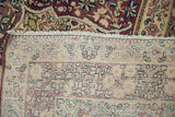 Tightly woven foundation and rich floral pile of an antique Kermanshah rug.