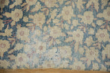 Antique Kermanshah carpet showing even wear, visible foundation, beige blossoms on blue.