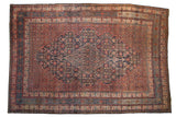 Vintage Persian Bibikabad carpet with a navy blue diamond medallion, red Herati field, and intricate borders.