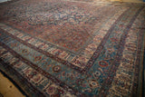 Angled view showing the intricate Herati borders and blue color variation on a vintage Bibikabad carpet.