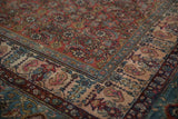 Corner detail of a vintage Bibikabad showing color abrashes in the blue and pink boteh border.