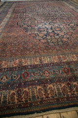 Low-angle view of the vintage Bibikabad carpet's borders showing detailed boteh and shrub motifs.