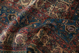 Richly colored boteh and Herati motifs on the folded, textured pile of a vintage hand-knotted Persian carpet.