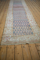 Long perspective shot of a vintage Malayer runner with time-softened color abrashes.