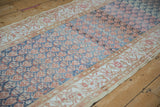 Long angle of a distressed Malayer runner showing the rainbow-like color shifts across the boteh field.