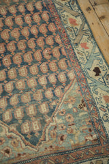 Layered texture of distressed Malayer runner with dusty teal boteh and arabesque border.