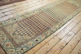 Distressed vintage Malayer runner with layered terracotta and teal boteh field.